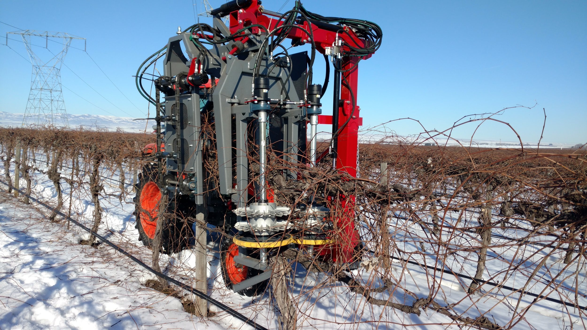 Vine Tech Concord pre-pruner working a snowy vineyard